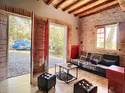 a living room with a couch and a table at GITES STE CATHERINE in Teyssode