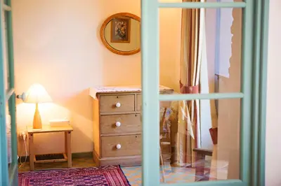 a room with a dresser and a mirror at The Balcony Gîte - Riverside Lagrasse in Lagrasse