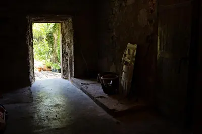 a dark hallway with a door in a house at The Balcony Gîte - Riverside Lagrasse in Lagrasse