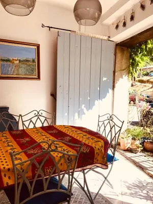 a patio with a table and chairs on a porch at La maison Vigne Vierge in Lagrasse