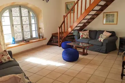 a living room with a couch and a table at La maison Vigne Vierge in Lagrasse