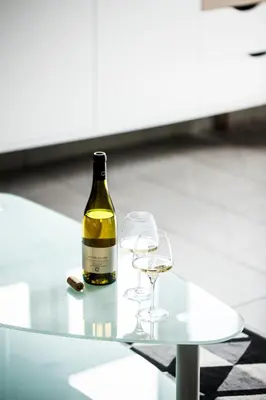 a bottle of wine and two glasses on a table at Domaine de Cazaban in Villegailhenc
