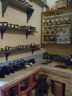 a kitchen with a bunch of shoes on shelves at Château de Vallègue in Vallègue