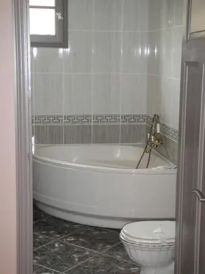a bathroom with a white tub and a toilet at Auberge des Lices in Carcassonne
