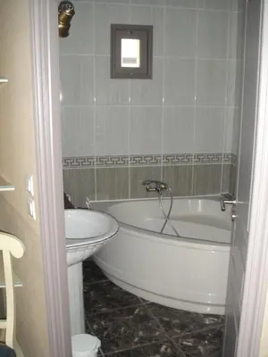 a bathroom with a white tub and a toilet at Auberge des Lices in Carcassonne