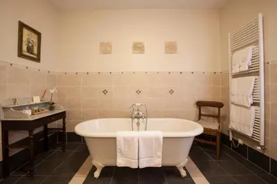 a bathroom with a tub and a sink at La Villa de Mazamet in Mazamet