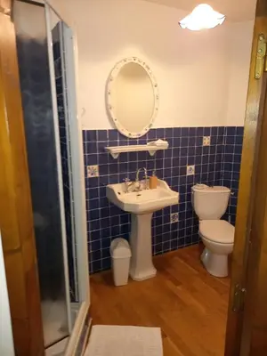 a bathroom with a sink and a toilet and a mirror at Chambres d'hôtes Sous L'Olivier in Trausse