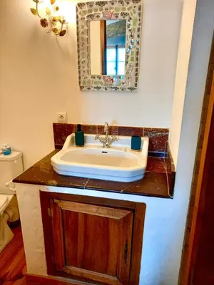 a wooden table with a counter top and a chair at Chambres d'hôtes Sous L'Olivier in Trausse