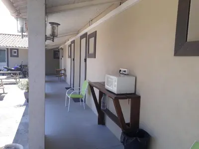 a hallway with a table with a laptop on it at Hotel Motel Limoux in Limoux