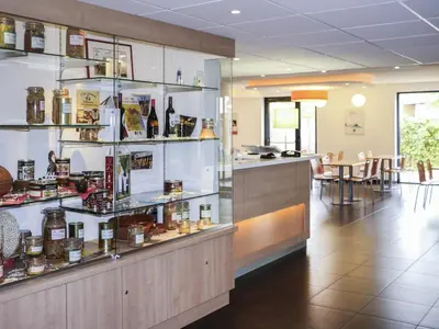 a large yellow building with a sign on it at ibis budget Castelnaudary - A61 in Castelnaudary
