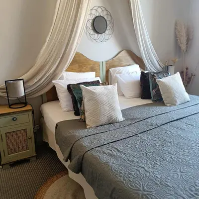 a bedroom with two beds with pillows on it at Entre Bastide et Cité et son rooftop in Carcassonne