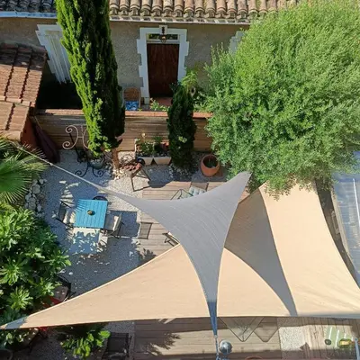 an overhead view of a patio with a tent and trees at Entre Bastide et Cité et son rooftop in Carcassonne