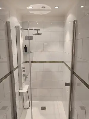a shower with a glass door in a bathroom at Entre Bastide et Cité et son rooftop in Carcassonne