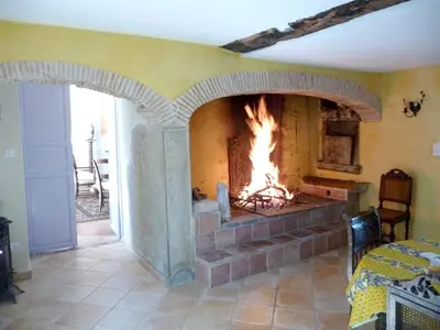 a fireplace in a living room with a fire in it at Manoir enchanteur à Cailhau avec piscine privée sécurisée in Cailhau