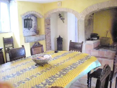 a dining room with a table with a yellow and blue pattern at Manoir enchanteur à Cailhau avec piscine privée sécurisée in Cailhau
