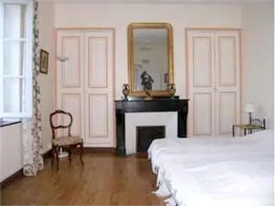 a bedroom with a bed and a mirror and a desk at Manoir enchanteur à Cailhau avec piscine privée sécurisée in Cailhau