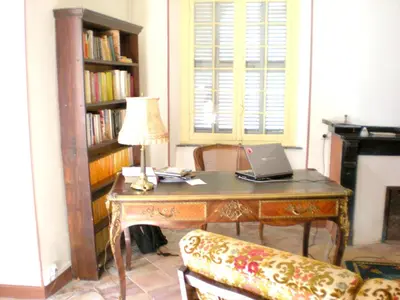 a room with a desk with a laptop on it at Manoir enchanteur à Cailhau avec piscine privée sécurisée in Cailhau