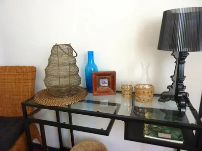a glass table with a lamp and other items on it at La Maison narbonnaise in Narbonne