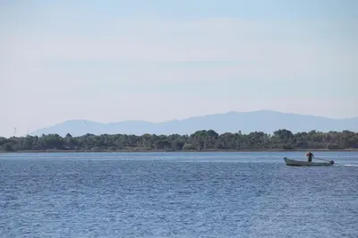 a man is rowing a boat in the water at La Maison narbonnaise in Narbonne