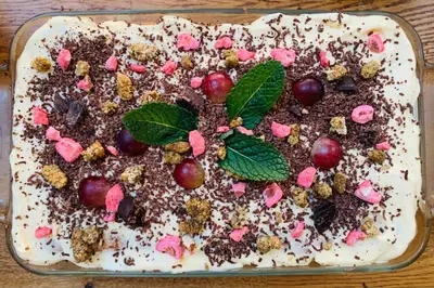 a cake with chocolate and cherries on a table at La Maison narbonnaise in Narbonne