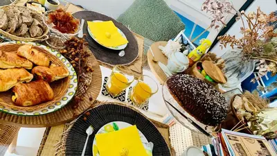 a table with plates of food and glasses of orange juice at La Maison narbonnaise in Narbonne