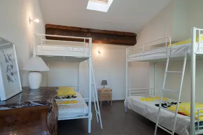 a bedroom with two bunk beds and a desk at Maison Borrel in Carcassonne