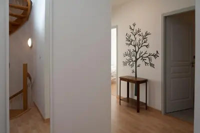 a hallway with a tree stencil on the wall at Maison Borrel in Carcassonne