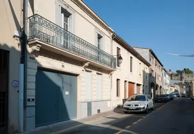 a car parked in front of a building with a garage at Maison Borrel in Carcassonne