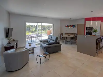 a living room with couches and a table and a kitchen at Luxury villa with private pool in Cesseras in Cesseras