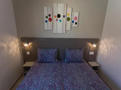 a bedroom with a bed with blue sheets and two pillows at Luxury villa with private pool in Cesseras in Cesseras