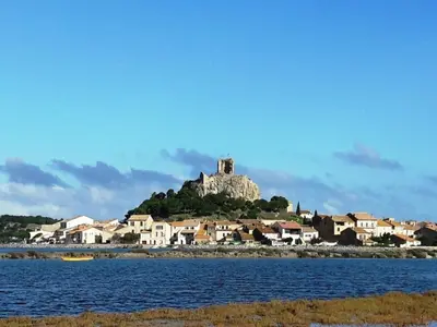 an island in the water with houses and a castle at Luxury villa with private pool in Cesseras in Cesseras