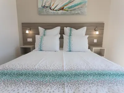 a bedroom with a white bed with blue and white pillows at Luxury villa with private pool in Cesseras in Cesseras