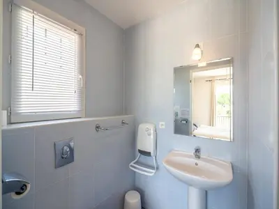 a white bathroom with a sink and a mirror at Wine Country Family Villa in Félines-Minervois