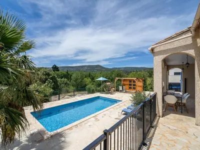 a swimming pool on a balcony next to a house at Wine Country Family Villa in Félines-Minervois