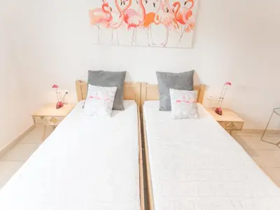 two twin beds in a room with two lamps at Modern villa with private pool in Pouzols-Minervois