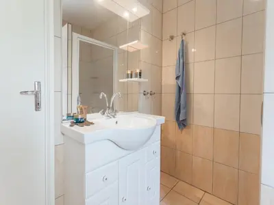 a bathroom with a white sink and a mirror at Modern villa with private pool in Pouzols-Minervois