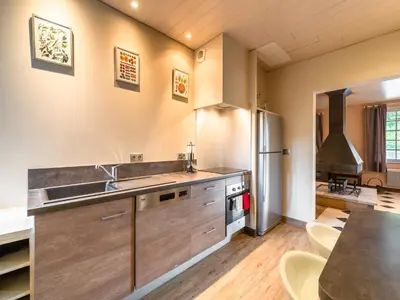 a kitchen with a sink and a refrigerator at Stone House St Denis with Pool & Views in Saint-Denis