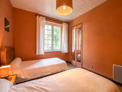 a bedroom with two beds and a window at Stone House St Denis with Pool & Views in Saint-Denis
