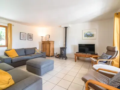 a living room with a couch and a tv at Modern Villa with Heated Pool in Beaufort