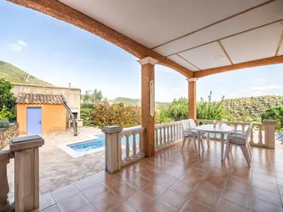 a patio with a table and chairs on a balcony at Hillside Retreat in Roquebrun in Roquebrun