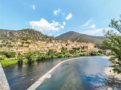 a view of a river with a town in the background at Hillside Retreat in Roquebrun in Roquebrun