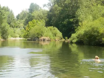 a person swimming in the water in a river at Hillside Retreat in Roquebrun in Roquebrun