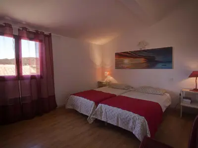 a bedroom with a bed with a red blanket at Villa in Beaufort with Private Pool in Beaufort