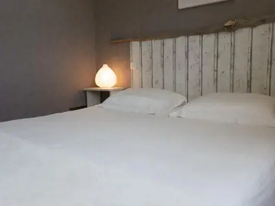 a bedroom with a white bed and a lamp at Villa in Beaufort with Private Pool in Beaufort