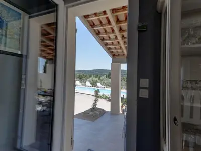 a door leading to the pool from a house at Villa in Beaufort with Private Pool in Beaufort