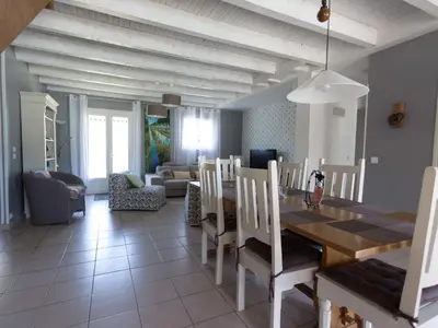 a dining room and living room with a table and chairs at Villa in Beaufort with Private Pool in Beaufort