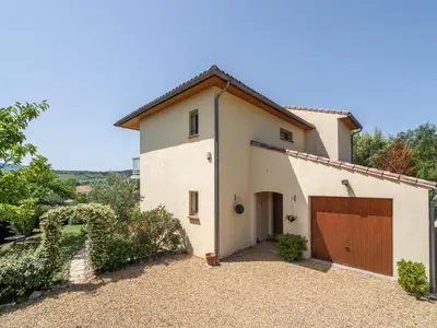a large white house with a brown garage at Villa in Limoux with Private Pool & Mountain Views in Limoux
