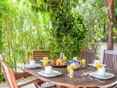 a wooden table with a tableasteryasteryasteryasteryasteryasteryasteryasteryasteryastery at Villa in Limoux with Private Pool & Mountain Views in Limoux