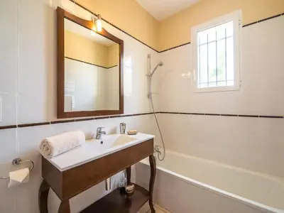 a bathroom with a sink and a tub and a mirror at Villa in Limoux with Private Pool & Mountain Views in Limoux