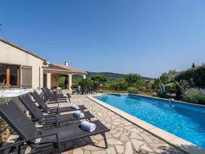 a villa with a swimming pool and lounge chairs at Relaxing Villa Near Lake & Beaches in Beaufort
